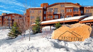 A snow-covered landscape with a large stone sign reading "Crestview."