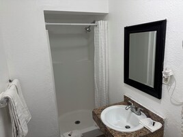 Standard Room, 1 Queen Bed | Bathroom | Rainfall showerhead, free toiletries, towels, soap