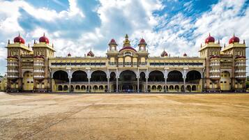 A large, ornate building with multiple domes and arches, featuring a central courtyard and symmetrical design.
