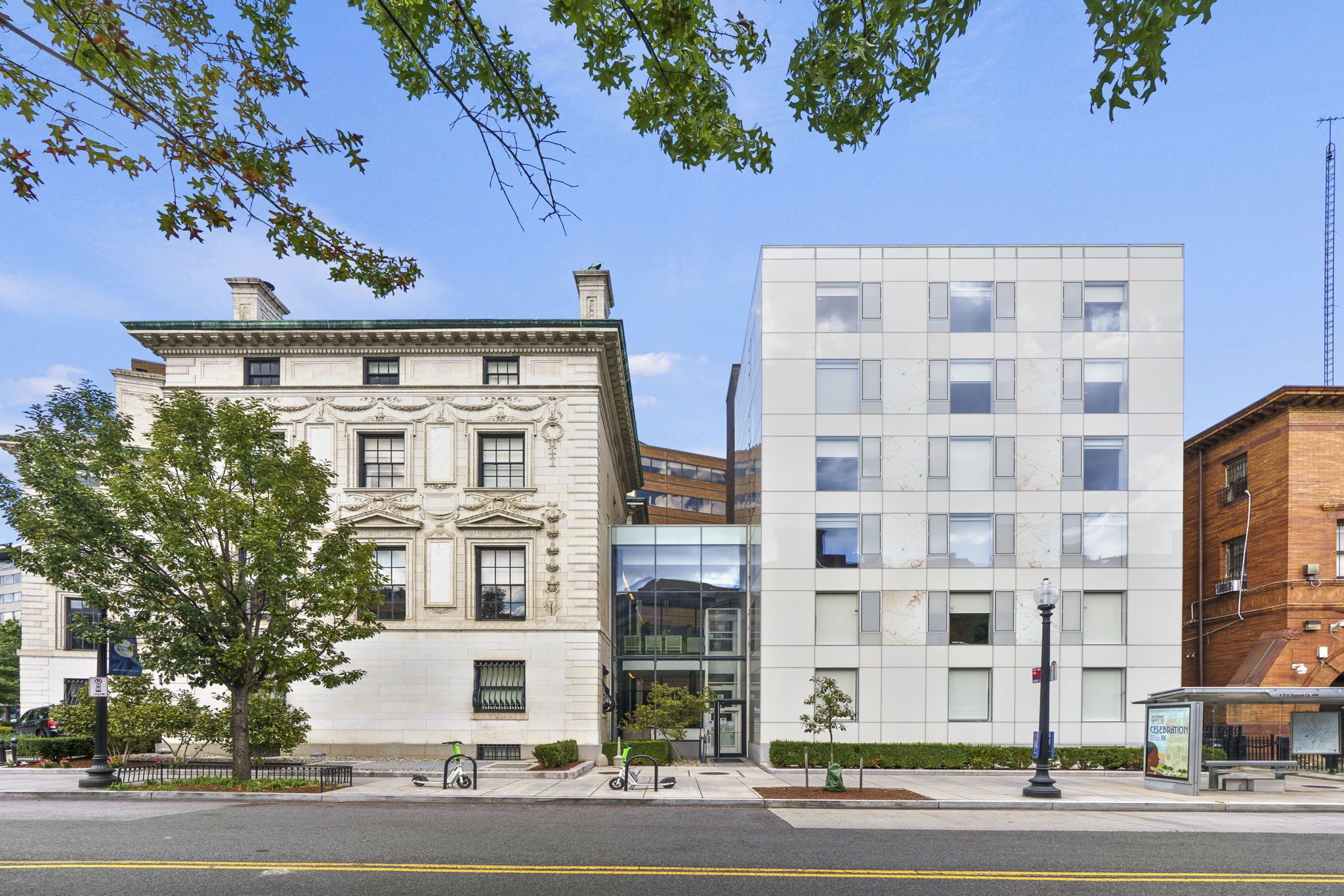 A historic building with a classical facade and a modern glass entrance.