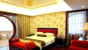 A hotel room with a large bed, a red sofa, and a view of the city. - Yingjia Resort (Lu'an)