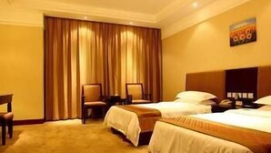 A hotel room with two beds, a desk, a chair, and a large window with curtains. - Yingjia Resort (Lu'an)