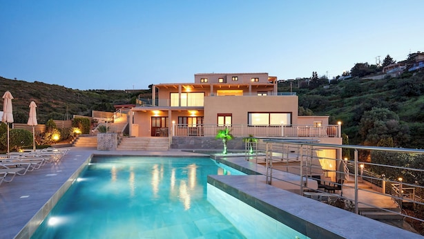 A modern hotel with a swimming pool, outdoor seating, and a hillside view. - "Ilios" apartment - 1 Bedroom Apt / Sea view /Shared Pool / Sleeps 4 (Malevizi)