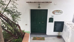 A white building with a green door, a small sign reading "Casa Rosetta," and a mailbox. - Casa Rosetta: A terrace on the sea paradise of the Amalfi Coast (Praiano)