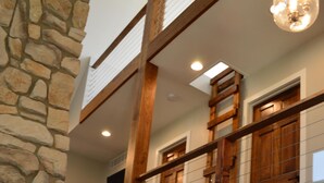 A staircase with wooden steps and a stone wall on one side. - Get back to nature and experience lake life in style when you stay at our house (Albion)