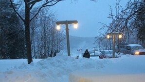 A snowy street with a person walking, streetlights, and parked cars. - Beautiful 3 BR ski In Trailside condo.  Steps away from WaterPark & Ice Rink  (Jay)