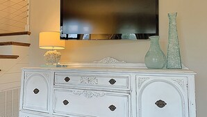 A white dresser with ornate carvings and a flat-screen TV mounted above it. - Coastal Comfort Near Shem Creek & Beaches – Walkable Location! (Mount Pleasant)