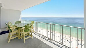 Ein Balkon mit Blick auf Strand und Meer.