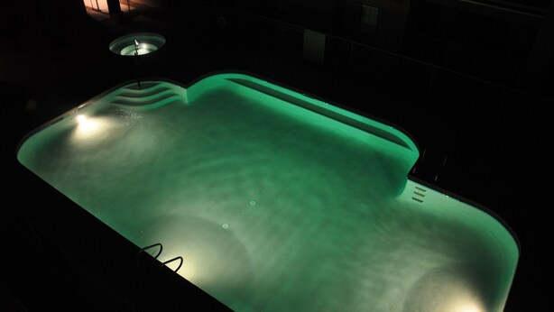A hot tub with a green light, surrounded by a dark environment. - Relax in beautiful and quiet Scottsdale condo. Heated pool/hot tub (Scottsdale)