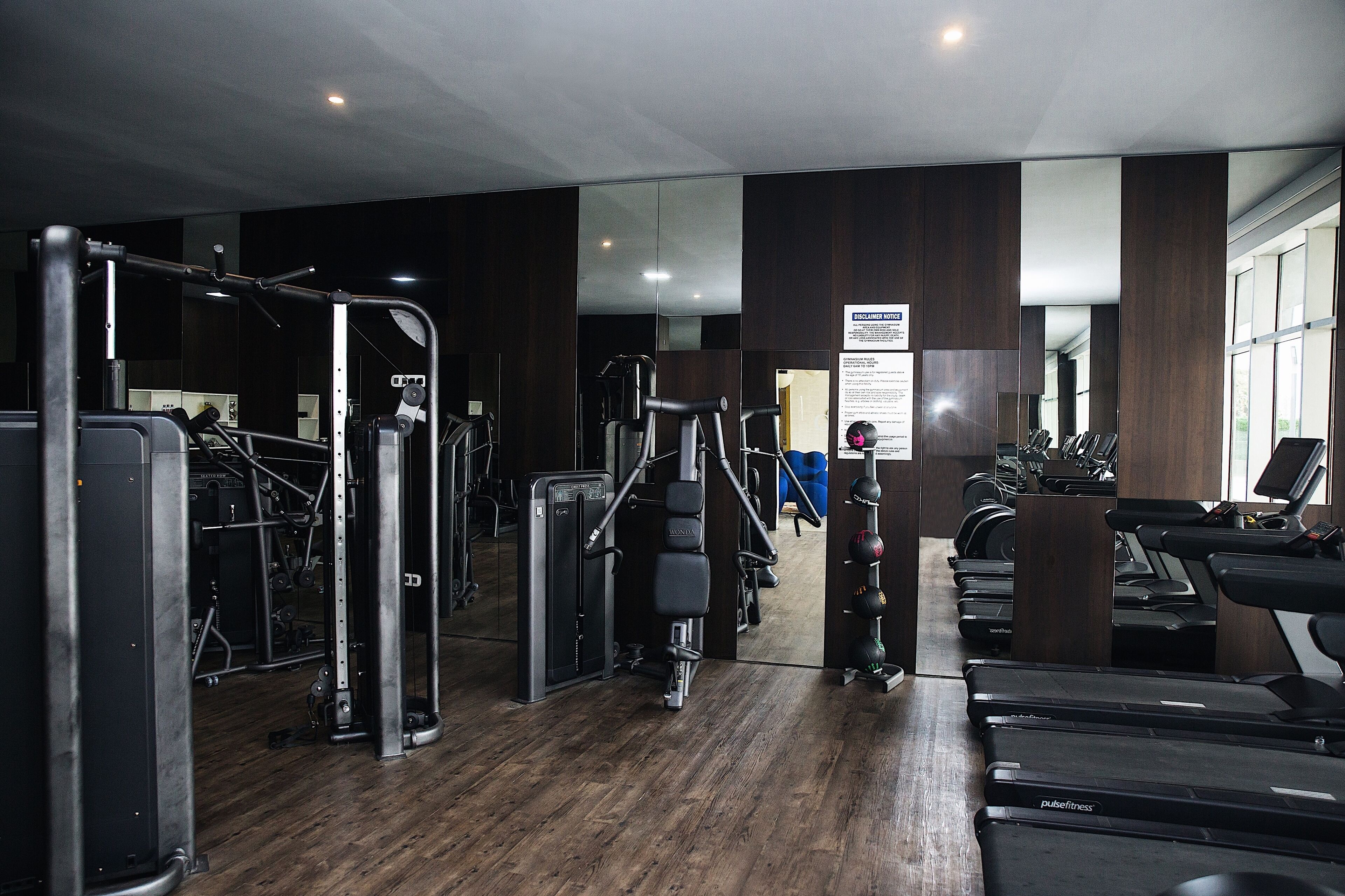 A gym with various exercise equipment, including treadmills and weight machines.