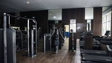 A gym with various exercise equipment, including treadmills and weight machines.