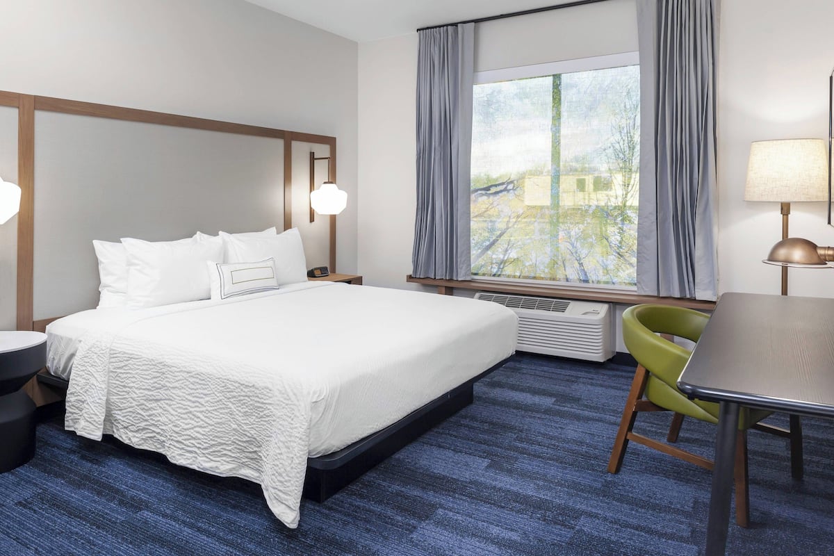 Hypo-allergenic bedding, desk, laptop workspace, blackout drapes