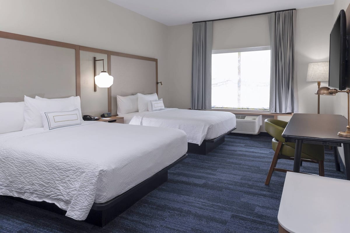 Hypo-allergenic bedding, desk, laptop workspace, blackout drapes