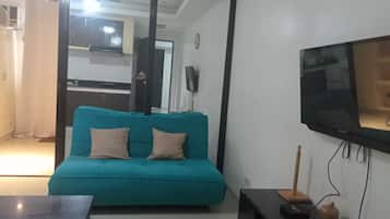 Deluxe Double Room | Living area | Flat-screen TV
