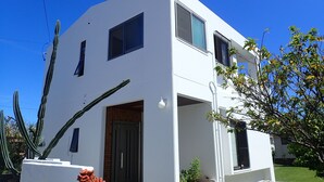 A modern two-story house with a flat roof, large windows, and a small porch area. - Smilax Kurichi (Uruma)