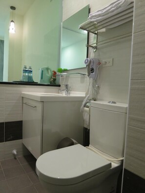 Een douche, een haardroger, pantoffels, handdoeken