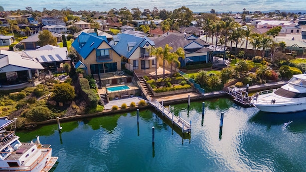 A residential area with a dock and a yacht.