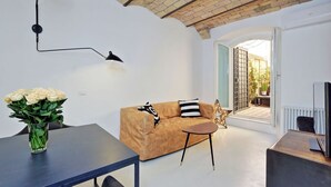 Ein modernes Wohnzimmer mit einer Couch, einem Couchtisch und einem Blumenstrauß.