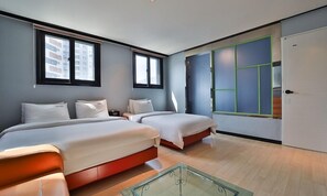 A modern hotel room with two beds, a glass coffee table, and large windows with blinds. - Busan Nampodong Hermes Hotel (Busan)