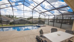 A covered outdoor area with a pool, chairs, and a table. - Ip60454 - Highgate at Legacy Park - 4 Bed 3 Baths Villa (Davenport)