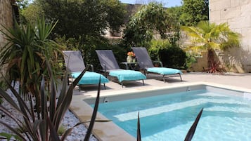 Seasonal outdoor pool, pool loungers