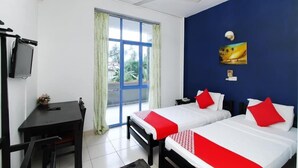 A hotel room with two beds, a desk, a television, and a window with curtains. - Oasis Wadduwa (Wadduwa)