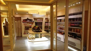 A well-lit store with wooden flooring and shelves stocked with various products. - Hotel Residence Solemare (Ricadi)