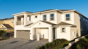 A two-story residential building with a garage, a covered entryway, and a small porch. - Je59003 - The Encore Club Resort - 9 Bed 8.5 Baths Villa (Kissimmee)