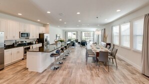 A spacious kitchen with a central island, modern appliances, and ample natural light. - Je59003 - The Encore Club Resort - 9 Bed 8.5 Baths Villa (Kissimmee)