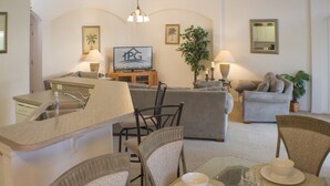 A modern kitchen with a dining area, featuring a sink, chairs, and a table set for dining. - Ip60460 - Highgate at Legacy Park - 4 Bed 3 Baths Villa (Davenport)