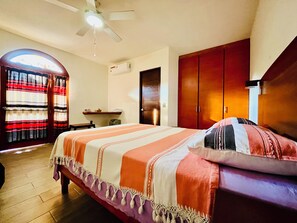Relax in this inviting space with a large bed, wooden wardrobe, and a desk for work or leisure.
