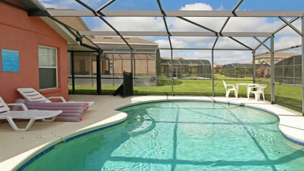 A covered outdoor swimming pool with lounge chairs and a patio area. - Smw148 - Sandy Ridge - 3 Bed 3 Baths Villa (Davenport)