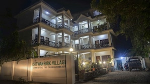 A multi-story building with balconies and a sign reading "Chitwan Park Village." - Chitwan Park Village (Sauraha)