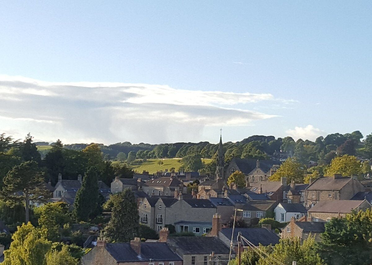 A town with historic buildings, a prominent church spire, and a mix of residential and commercial structures.