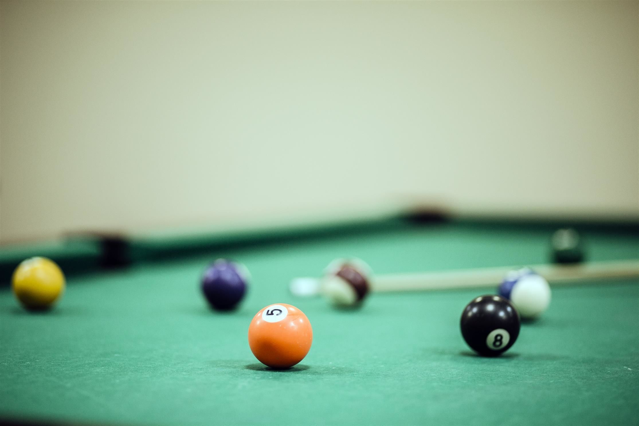 A close-up of a pool table with numbered balls.