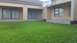 A building with a flat roof, large windows, and satellite dishes on the roof. - Styled Bed and Breakfast (Palapye)