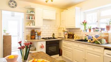 Full-sized fridge, microwave, coffee/tea maker, cookware/dishes/utensils