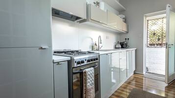 Full-size fridge, microwave, coffee/tea maker, cookware/dishes/utensils