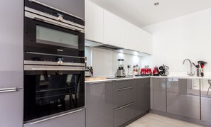 Microwave, stovetop, coffee/tea maker, cookware/dishes/utensils