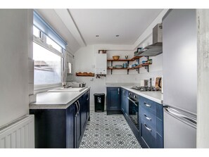 Full-sized fridge, microwave, coffee/tea maker, cookware/dishes/utensils