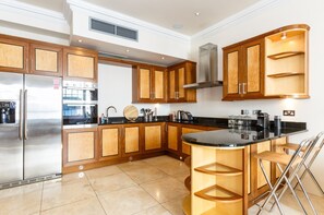 Stort kylskåp, mikrovågsugn, spishäll och kaffe- och tebryggare