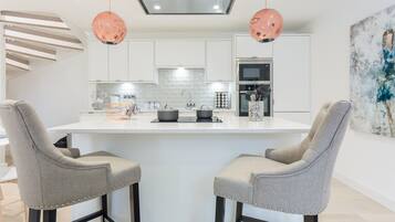 Full-size fridge, microwave, coffee/tea maker, cookware/dishes/utensils