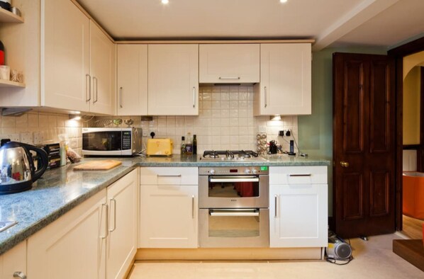 Full-sized fridge, microwave, coffee/tea maker, cookware/dishes/utensils