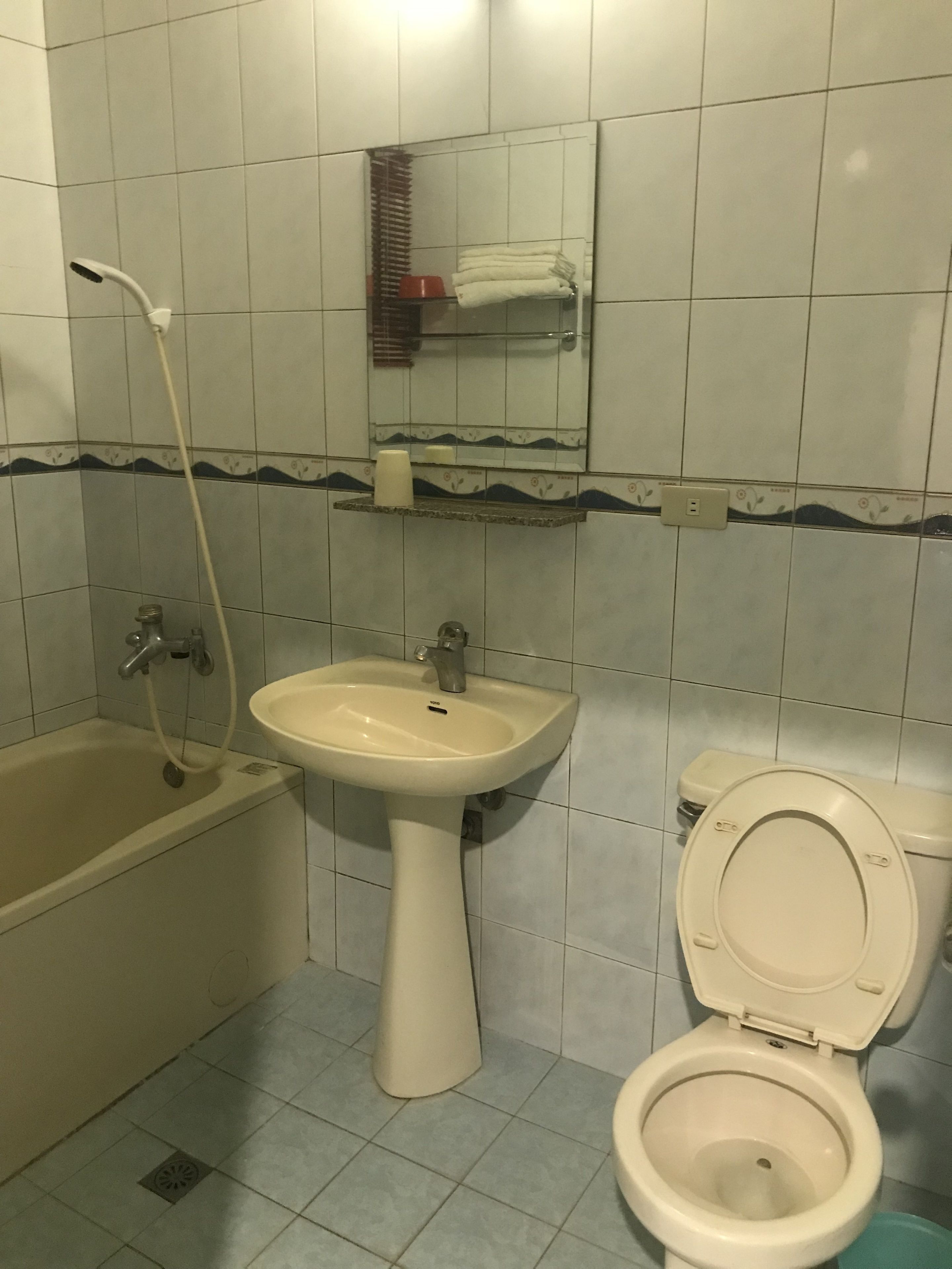 A bathroom with a bathtub, sink, and toilet.