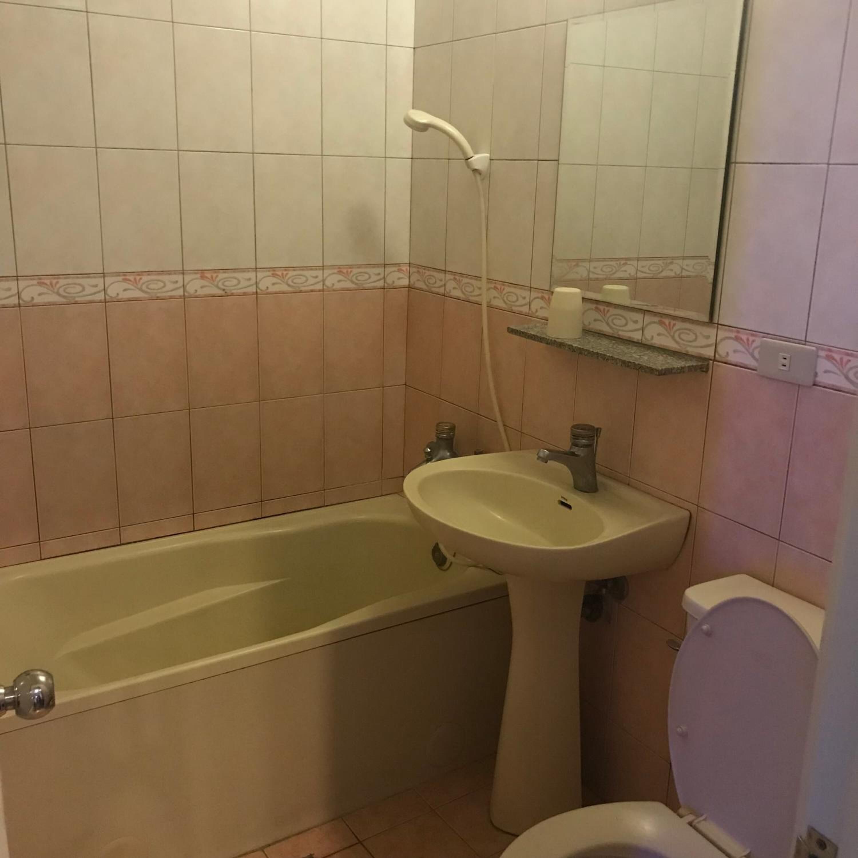 A bathroom with a bathtub, sink, and toilet.