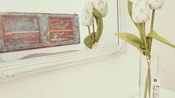 A vase with white flowers on a white surface.