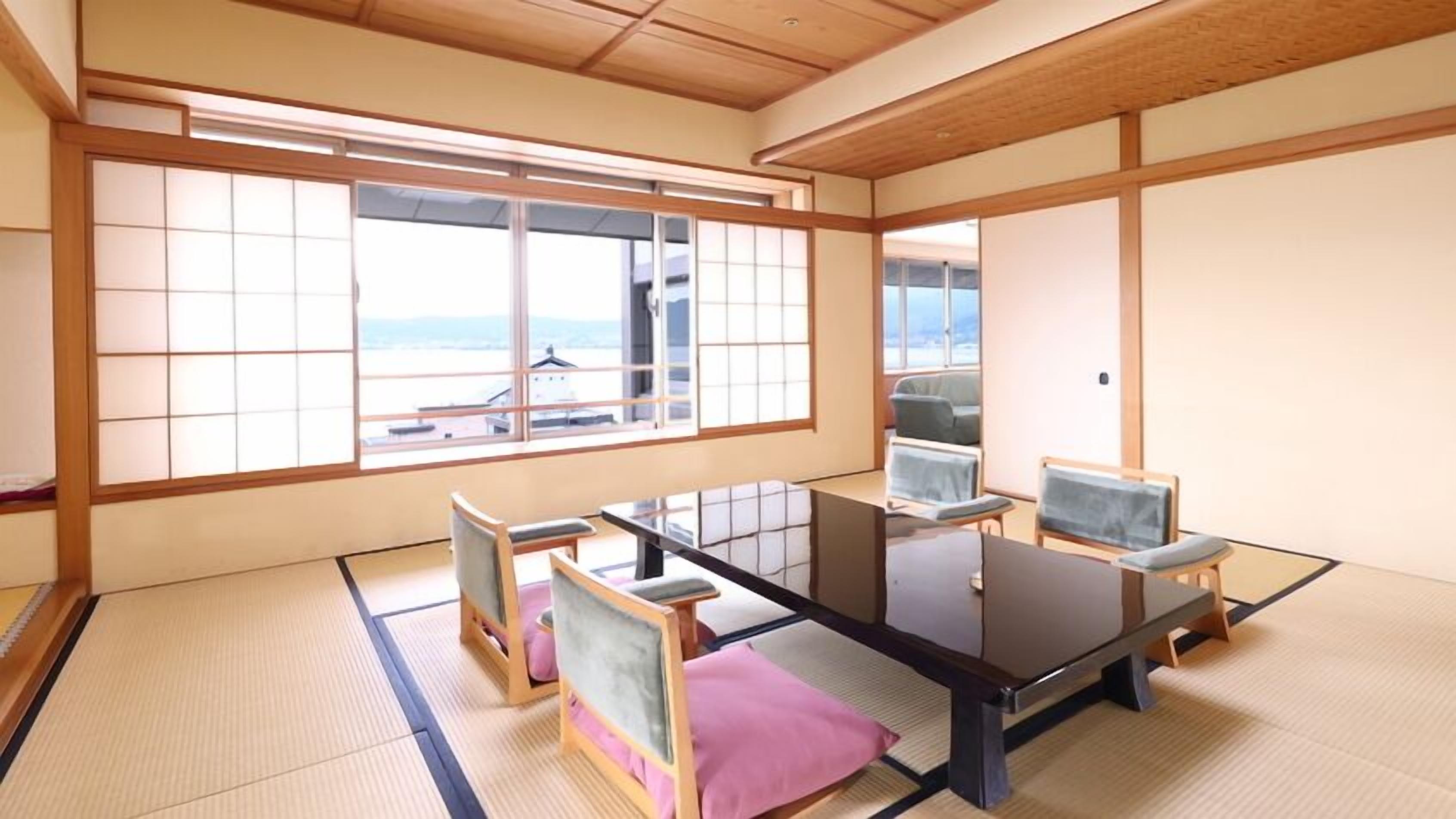 Una habitación japonesa tradicional con suelo de tatami, una mesa baja y paneles shoji.