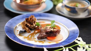 A plate of food with a blue rim, accompanied by a bowl and a cup on a table. - Hamanoyu (Suwa)