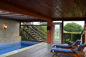 Indoor pool, open 7:00 AM to 7:00 PM, pool loungers