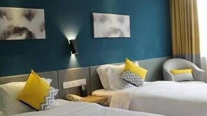 A hotel room with two beds, a nightstand, a wall-mounted lamp, and artwork on the wall. - Chengdu Yijin Hotel (Chengdu)